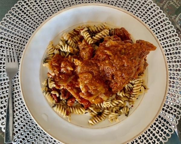 rustic chicken cacciatore over sundried tomato-spinach pasta